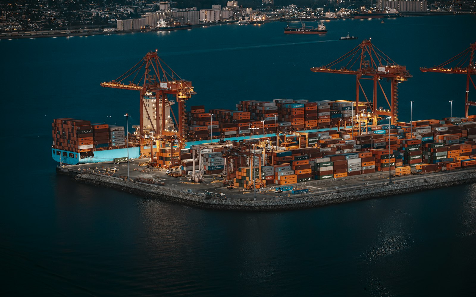 Container ship and cranes at a busy shipping port